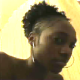 A low-resolution video clip featuring a black girl farting repeatedly while sitting on a toilet.